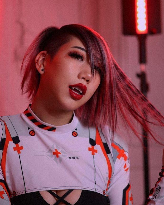 Woman with mini raccoon tails with pops of red and black