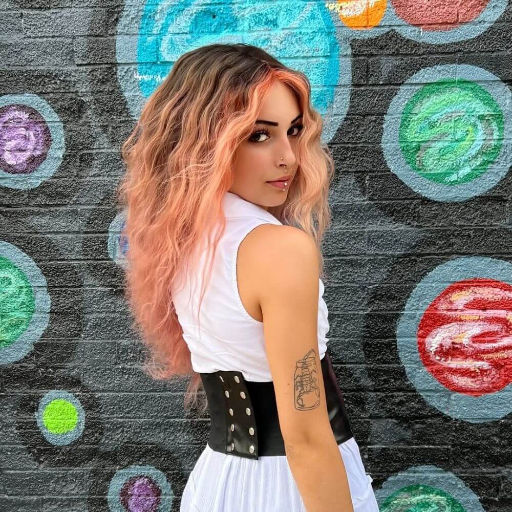 A smokey shadow root and perfectly peach balayage created with PRAVANA ChromaSilk HydraGloss.