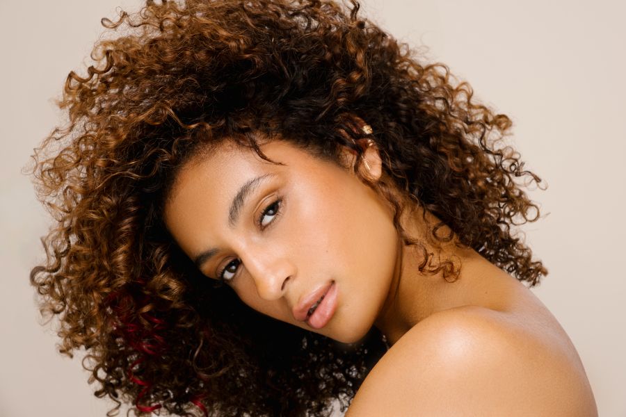PRAVANA ChromaSilk HydraGloss 6GC brunette hair color with hydrated natural coils, healthy shine, and beach-ready texture.